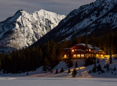lodge at night set against a mountain