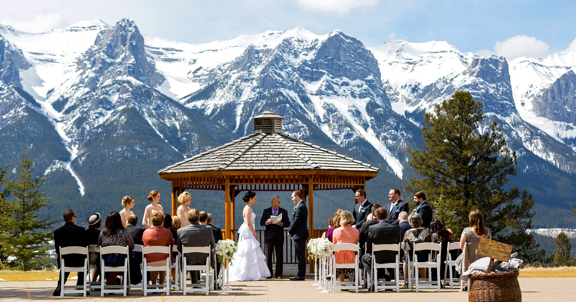 A wedding ceremony with mountains as backdrop