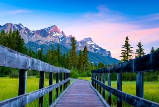 a boardwalk with mountains in the distance
