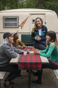 people sitting talking at a picnic table