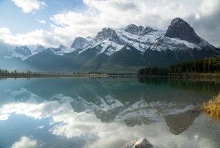 the rundle forebay in the spring with mountains in the background