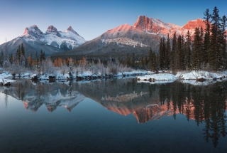 a panoramic shot of mountains in canmore taken from the three sisters viewpoint in the winter