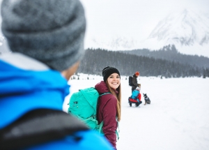a group of people snowshoeing through the mountains in the winter