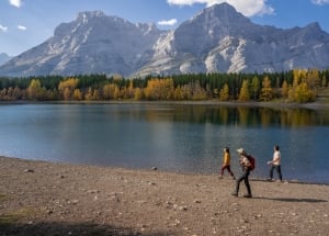 a group walking next to mount lorette ponds in the fall