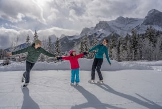 a family ice skating at the canmore nordic centre