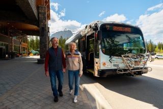two people exiting the roam transit bus at the malcolm hotel
