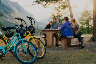 a group enjoying a post-bike ride picnic in the summer
