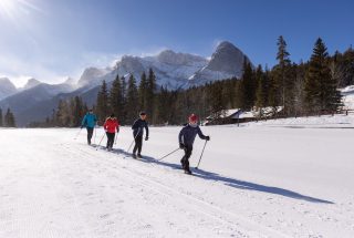 a family cross country skiing at the canmore nordic centre