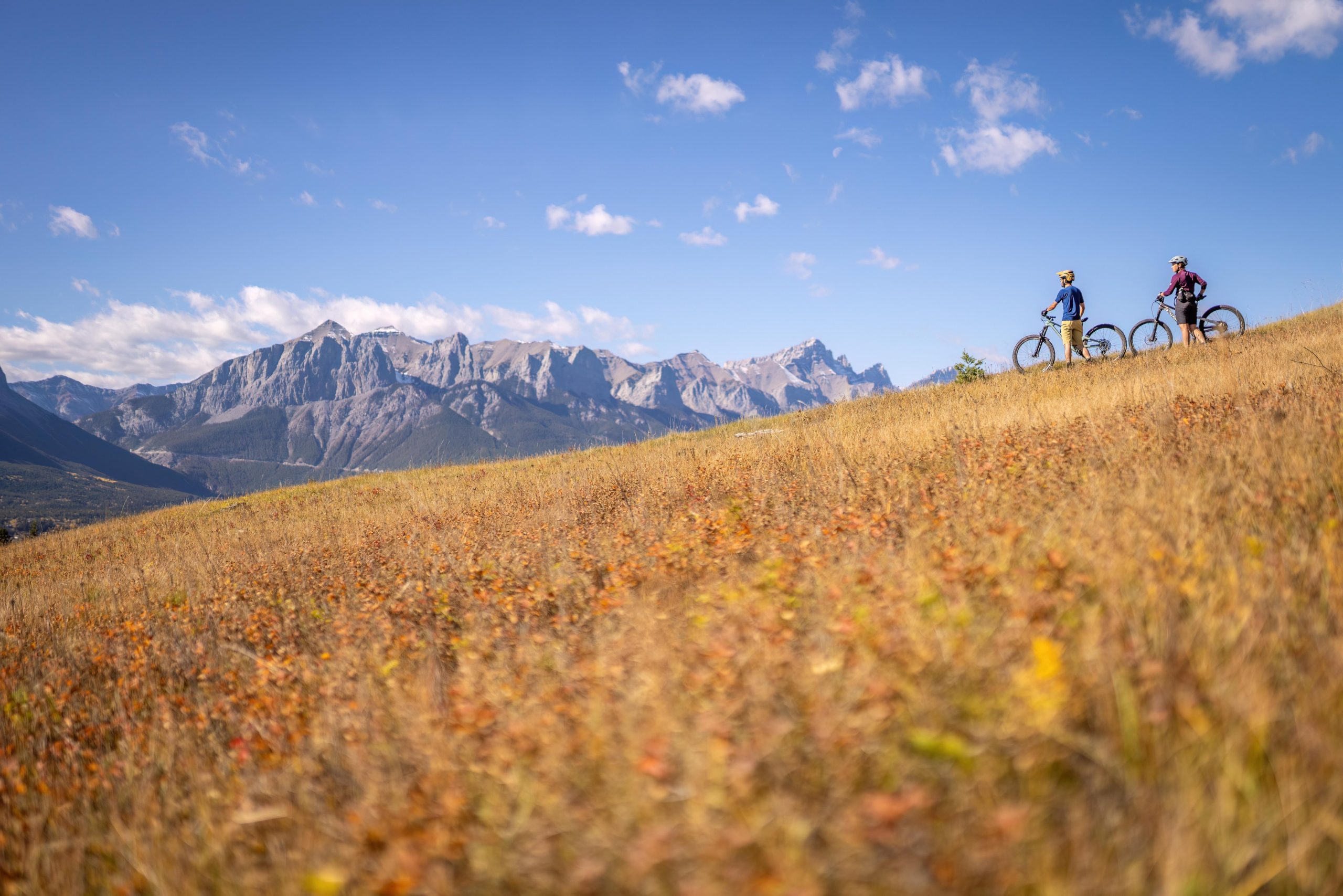 two mountain bikers gazing out into the mountain range