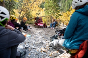 A group on an adventure tour with souls of miistaki listening to Indigenous elders share stories