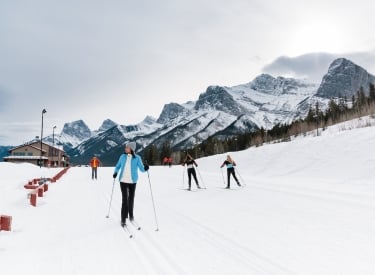 People cross-country skiing on trails at the Canmore Nordic Centre