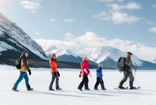 a family snowshoeing on spray lakes in kananaskis