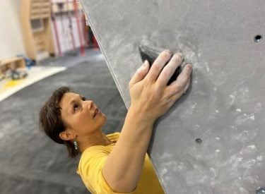 A woman climbing on a climbing wall