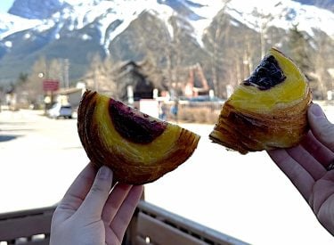 two people enjoying pastries on a food tour with three sisters tours