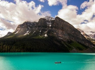a canoe drifting along lake louise
