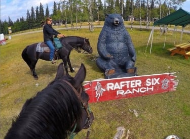 two people on horseback at the Rafter Six Ranch Resort