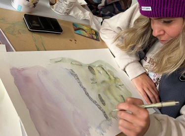 A person painting at a Listen Studio workshop