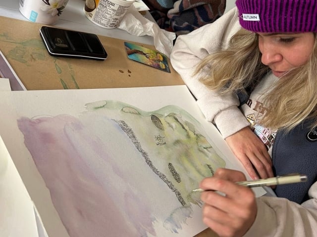 A person painting at a Listen Studio workshop