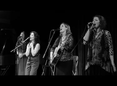 Black and white photo of the group Chick & Chang performing on stage